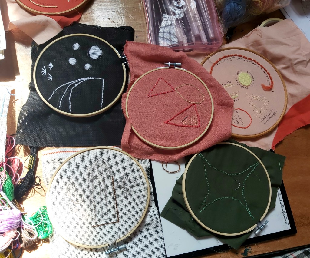 a selection of embroidery hoops showing various designs created in a workshop