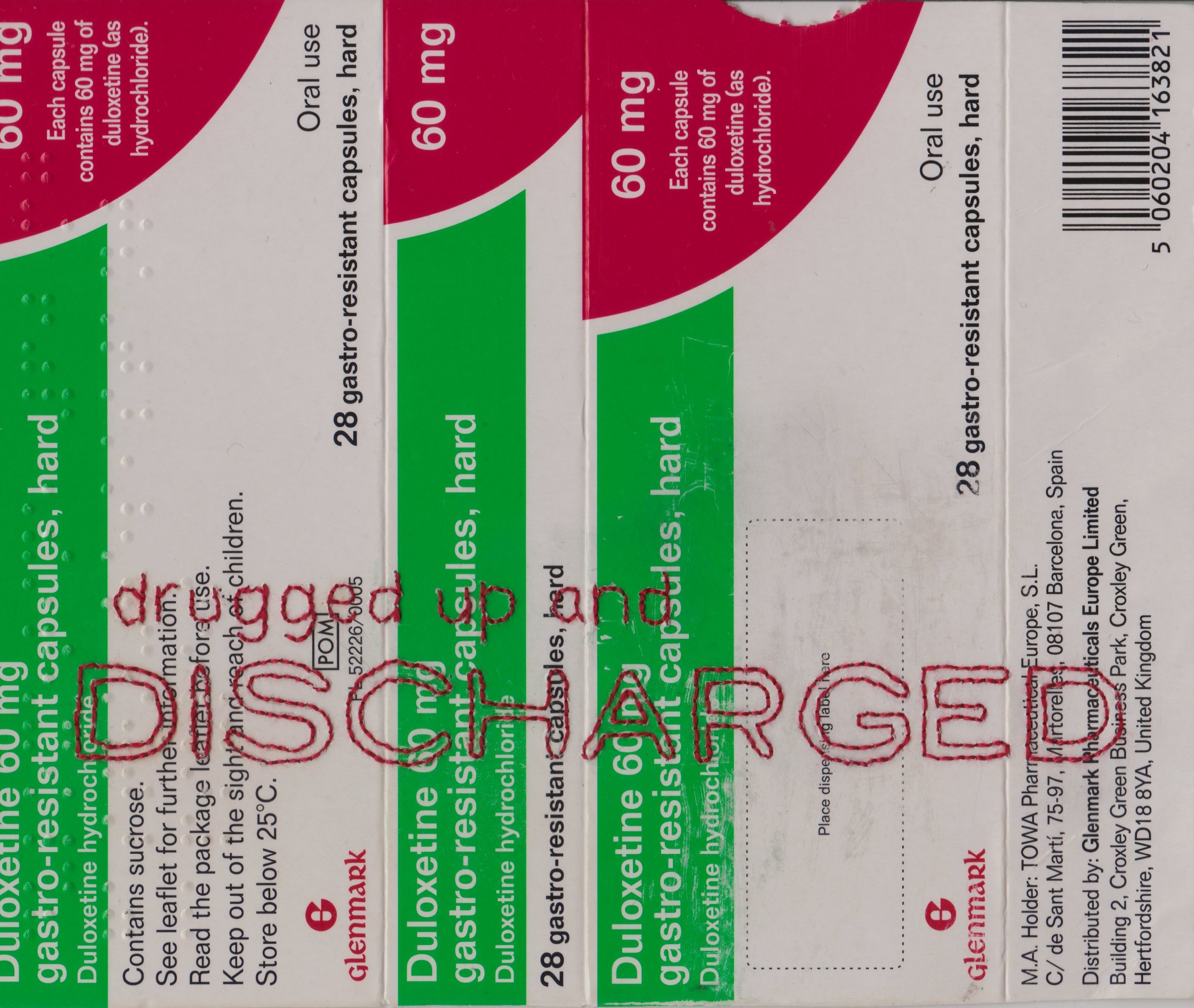 A green, white and pink medication packet for anti-depressants has been embroidered with the words "drugged up and discharged". "discharged" has been stitched in capital letters, spanning the width of the packet, whereas the other words are in a lower case.