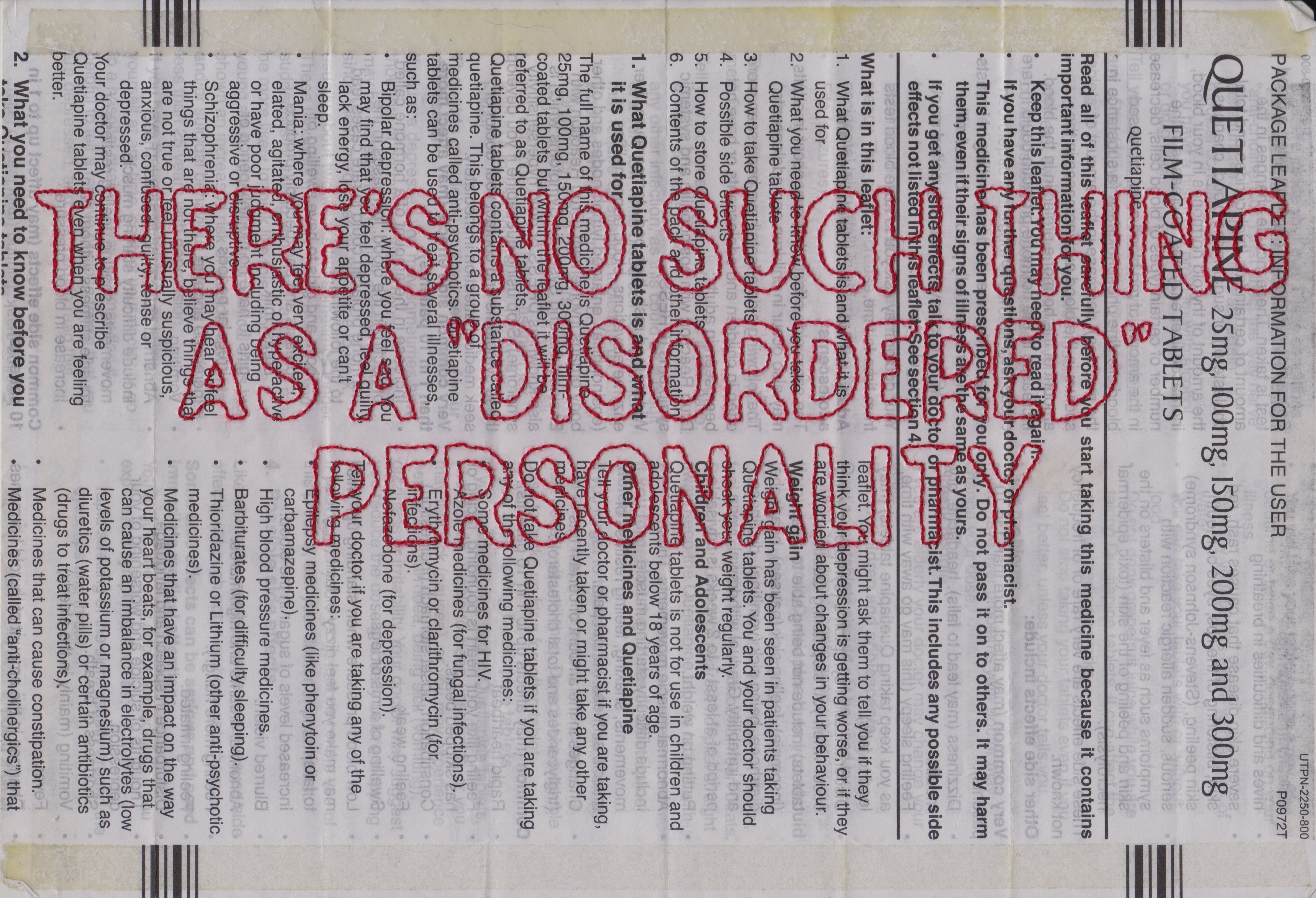 The words "there's no such thing as a 'disordered' personality" have been hand stitched in red on a white medication leaflet, in large outlined capital letters.